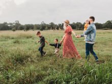 Family Walking Through Grass